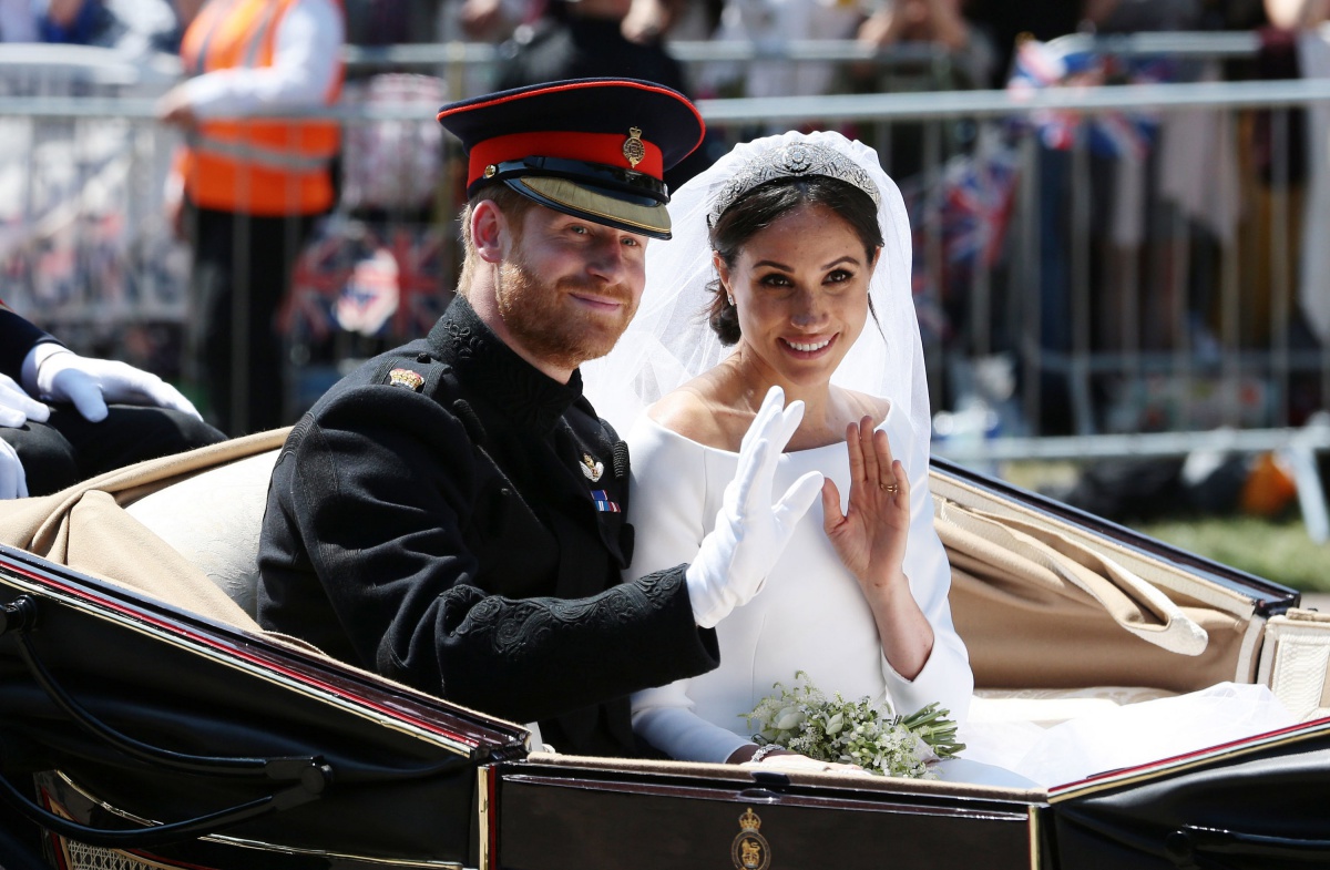 Prince Harry, Duke of Sussex and Meghan, Duchess of Sussex wave from the Ascot Landau Carriage during their carriage procession on Castle Hill outside Windsor Castle in Windsor, on May 19, 2018 after their wedding ceremony. (Photo by Aaron Chown - WPA Pool/Getty Images)