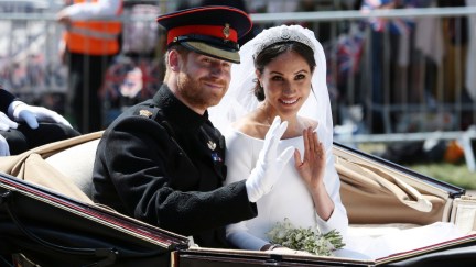 Prince Harry, Duke of Sussex and Meghan, Duchess of Sussex wave from the Ascot Landau Carriage during their carriage procession on Castle Hill outside Windsor Castle in Windsor, on May 19, 2018 after their wedding ceremony. (Photo by Aaron Chown - WPA Pool/Getty Images)