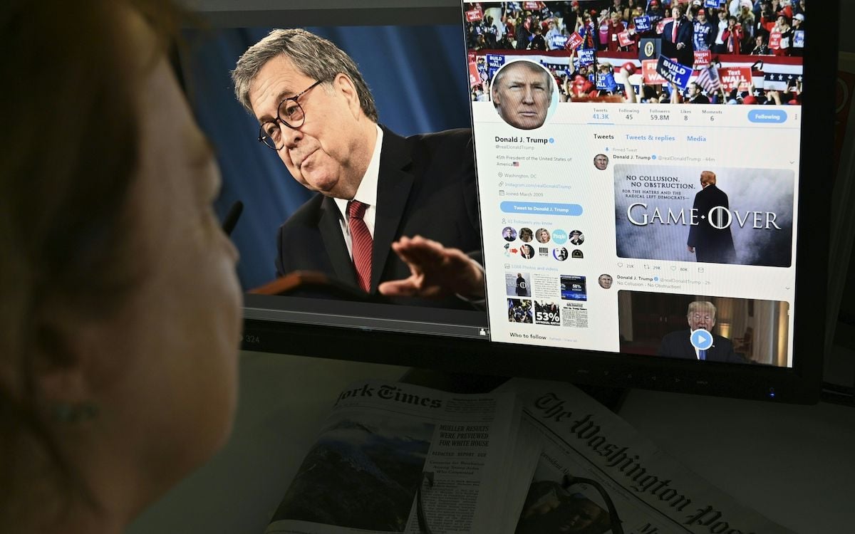 A photo illustration dated April 18, 2019 in Washington, DC shows an editor looking at a photograph of US Attorney General William Barr (L) speaking about the release of the redacted version of the Mueller report, juxtaposed with US President Donald Trump's latest tweet (R) "Game Over," using a "Game of Thrones" style montage that pictures him standing in dramatic fog.