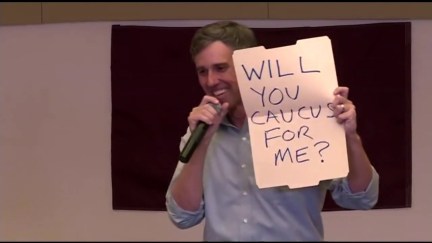 Beto O'Rourke holds up a sign asking a girl in the audience 