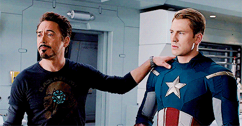 Captain America smacks Iron Man's hand off his shoulder in Marvel's The Avengers.