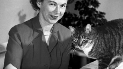 Young Beverly Cleary with her cat in black and white.