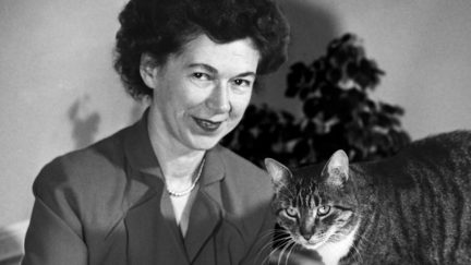 Young Beverly Cleary with her cat in black and white.