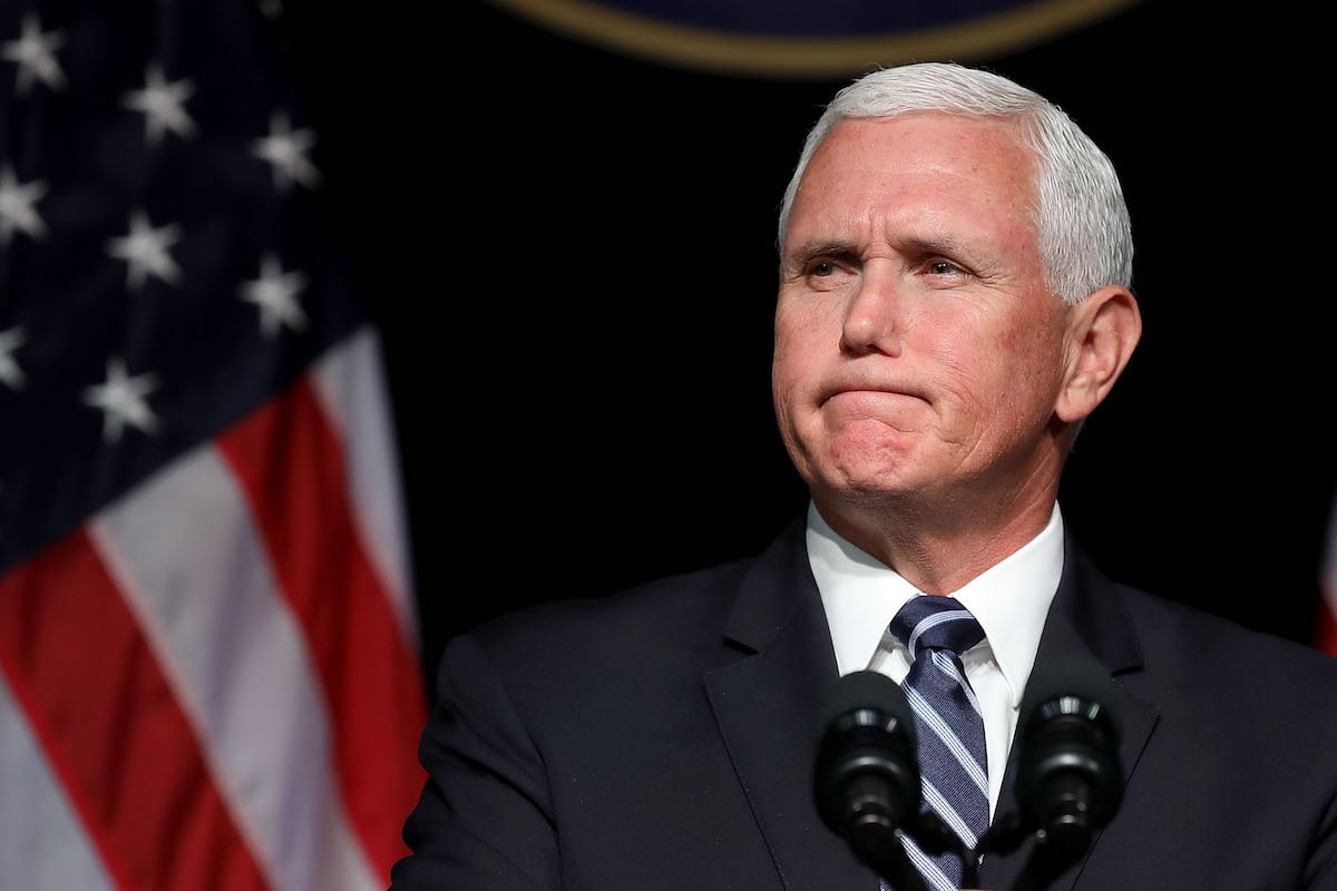 Mike Pence looks unhappy in front of the American flag.