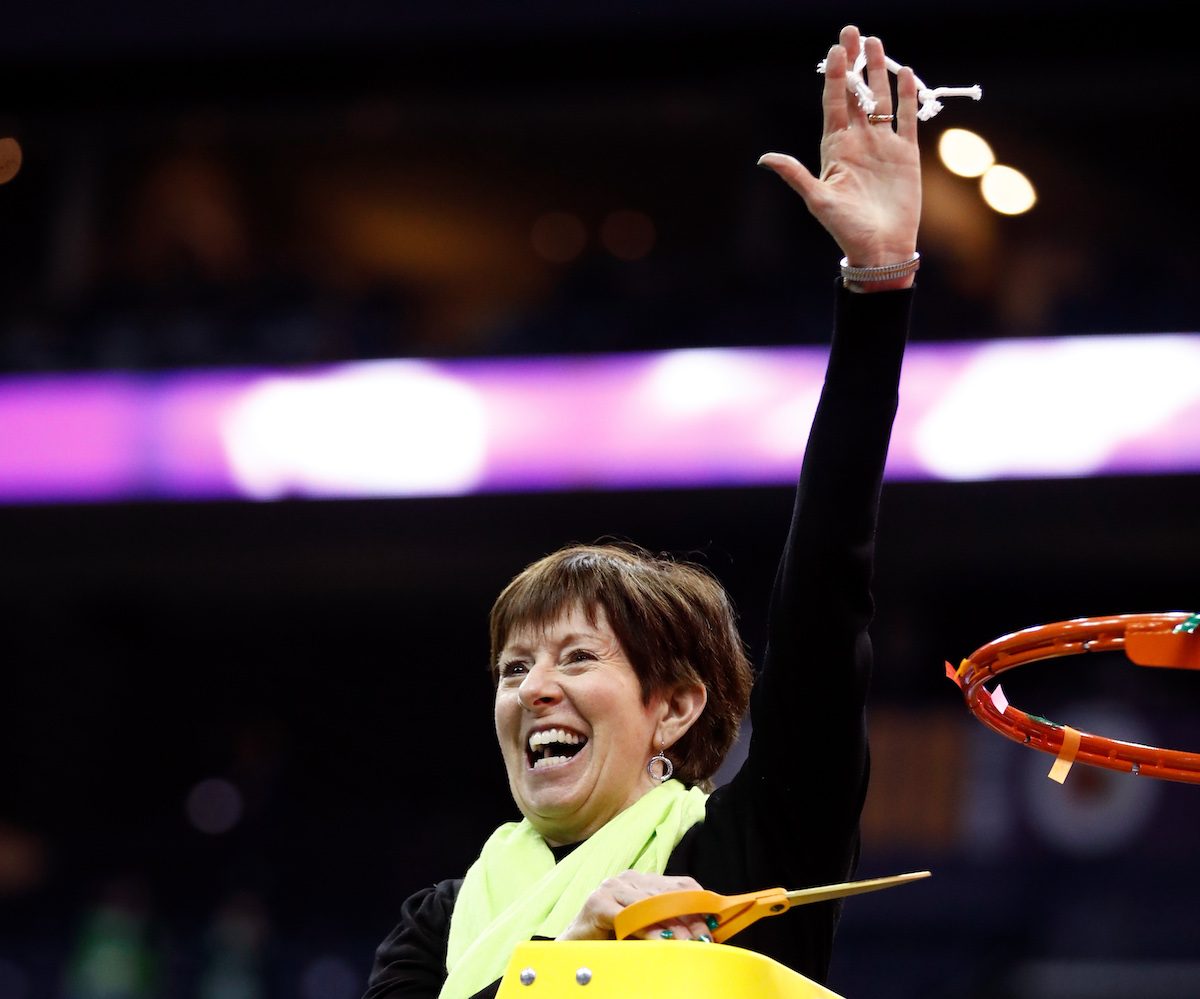 Notre Dame coach Muffet McGraw cuts down the net after a win