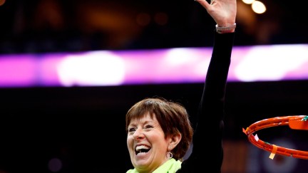 Notre Dame coach Muffet McGraw cuts down the net after a win