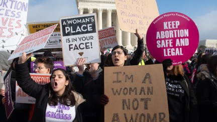 Pro-choice activists holding signs at a rally.