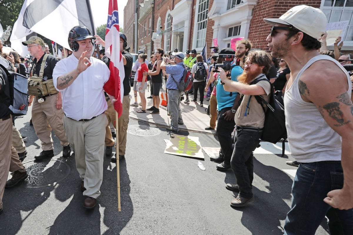 CHARLOTTESVILLE, VA - AUGUST 12: Hundreds of white nationalists, neo-Nazis and members of the 'alt-right' are confronted by protesters as they march down East Market Street toward Emancipation Park during the 'Unite the Right' rally August 12, 2017 in Charlottesville, Virginia. After clashes with anti-fascist protesters and police the rally was declared an unlawful gathering and people were forced out of Emancipation Park, where a statue of Confederate General Robert E. Lee is slated to be removed.
