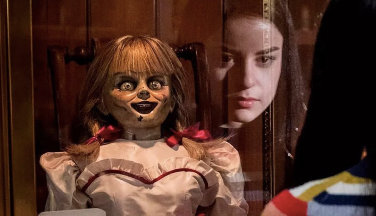 Spooky Annabelle doll being stared at by a child.