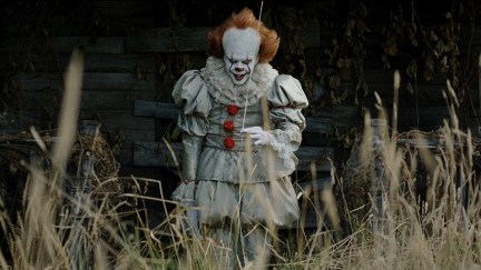 Pennywise (Bll Skarsgård) tries to catch a new victim in a still from IT: Chapter One.