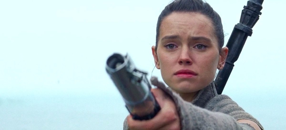 Rey holding Anakin's lightsaber out to Luke Skywalker at the end of Star Wars: The Force Awakens.