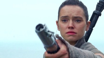 Rey holding Anakin's lightsaber out to Luke Skywalker at the end of Star Wars: The Force Awakens.