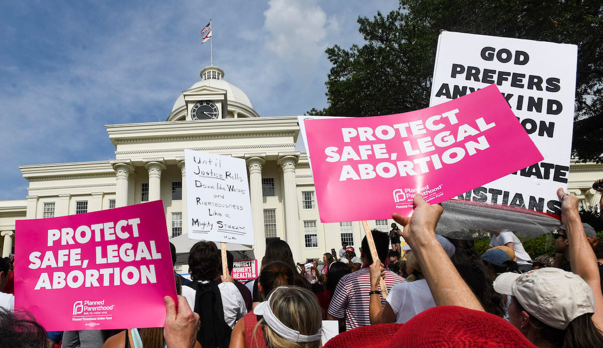 Protestors participate in a rally against one of the nation's most restrictive bans on abortions