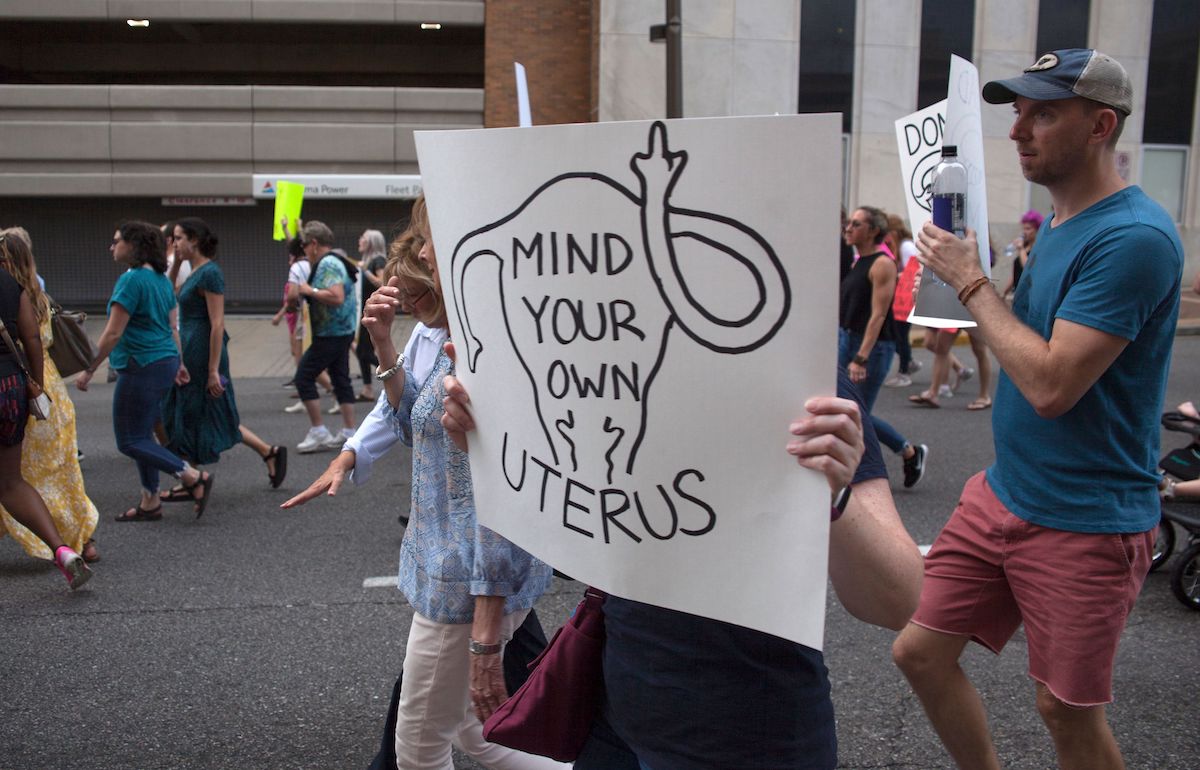 Pro-Abortion protest sign reading 'mind your own uterus'