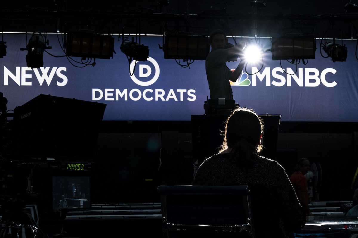 Workers set up a television set for the first Democratic primary debates.