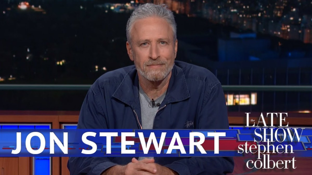 Jon Stewart glares from behind the Late Show desk.