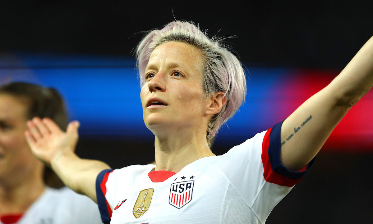 Megan Rapinoe celebrates a goal with open arms.