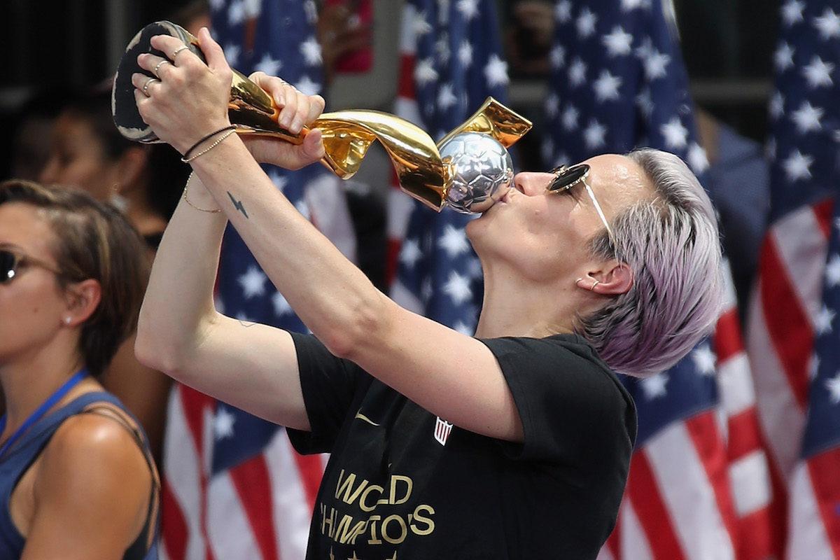 Megan Rapinoe kisses the trophy she earned.