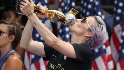 Megan Rapinoe kisses the trophy she earned.