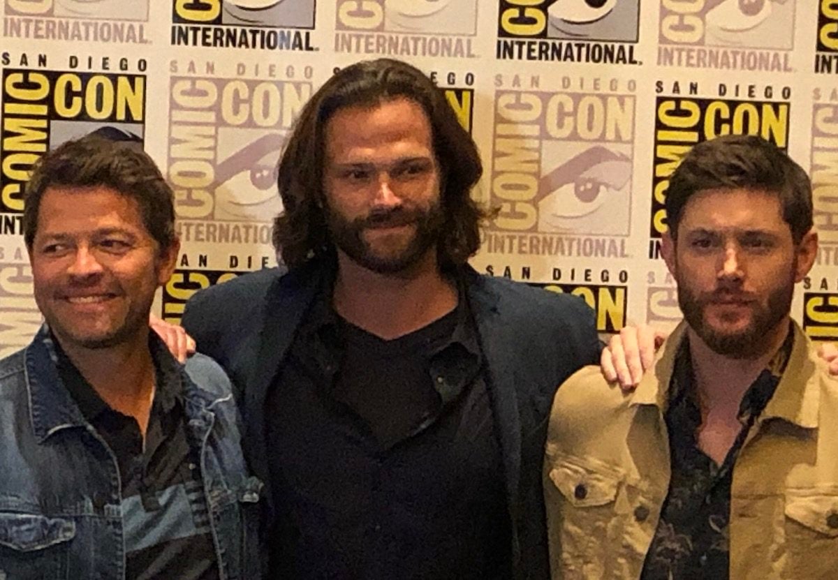 The CW's Supernatural cast posing for a photo at Comic-Con.