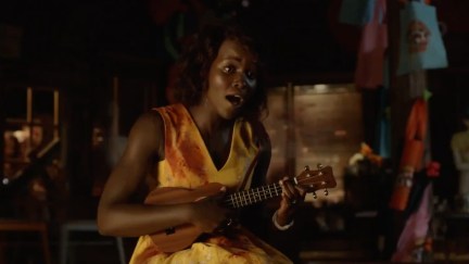 Miss Caroline (Lupita Nyong'o) keeps calm and carries on during a zombie attack in Little Monsters.