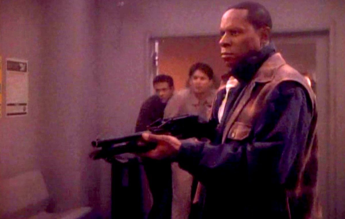 Avery Brooks as Benjamin Sisko, brandishing a shotgun in Star Trek: Deep Space Nine's "Past Tense"(1993).