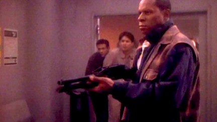 Avery Brooks as Benjamin Sisko, brandishing a shotgun in Star Trek: Deep Space Nine's 