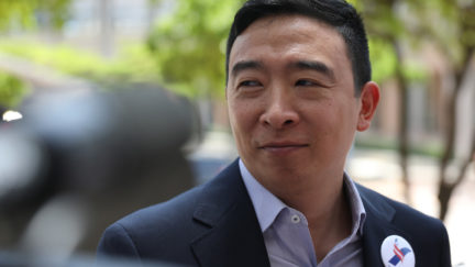 Andrew Yang speaks to media outside.