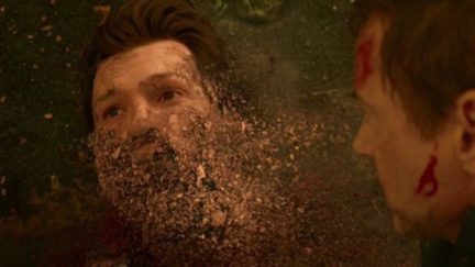 Spider-Man crumbling into dust as Tony Stark watches in Marvel's Avengers: Infinity War.