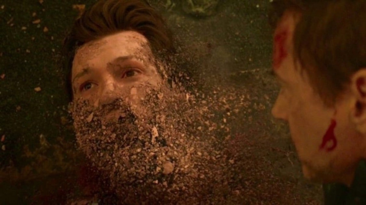 Spider-Man crumbling into dust as Tony Stark watches in Marvel's Avengers: Infinity War.