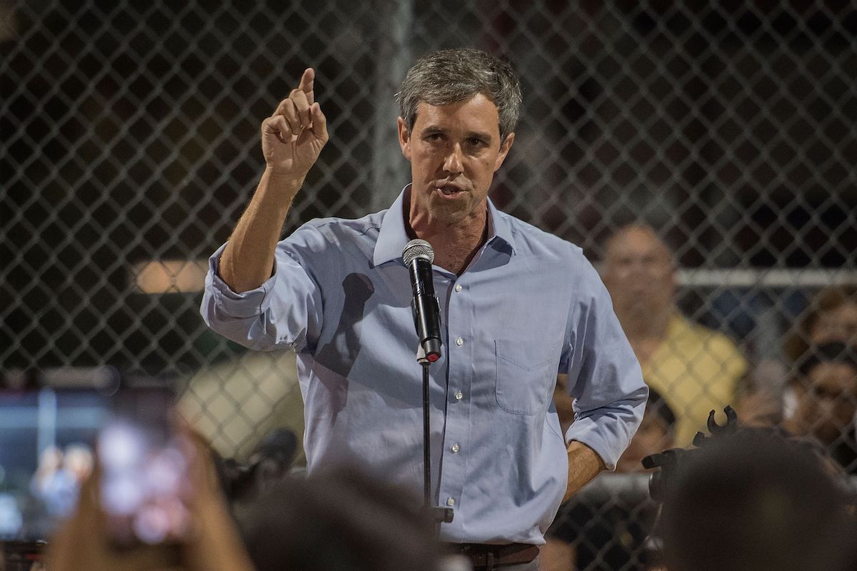 Beto O'Rourke speaks to the crowd during a prayer and candle vigil.