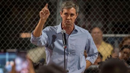 Beto O'Rourke speaks to the crowd during a prayer and candle vigil.