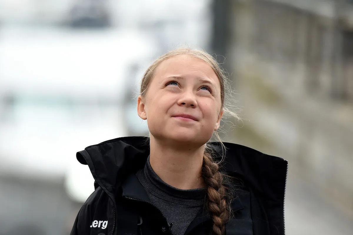 Teenage climate activist Greta Thunberg looks up at the sky.