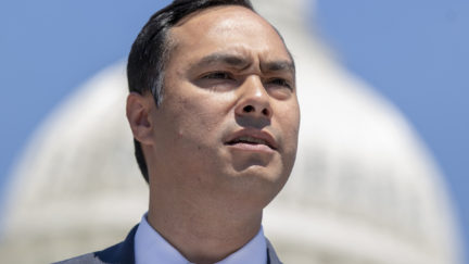 Rep. Joaquin Castro speaks with the Capitol Building in the background.