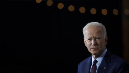 Joe Biden against a black background.