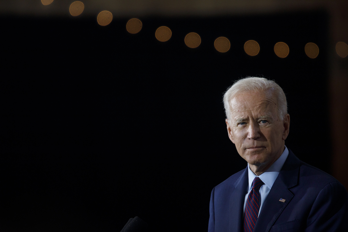 Joe Biden against a black background.