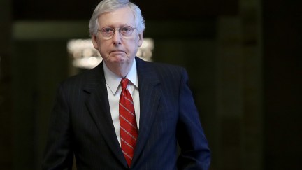 Mitch McConnell, the absolute worst, walks through the Capitol Building.