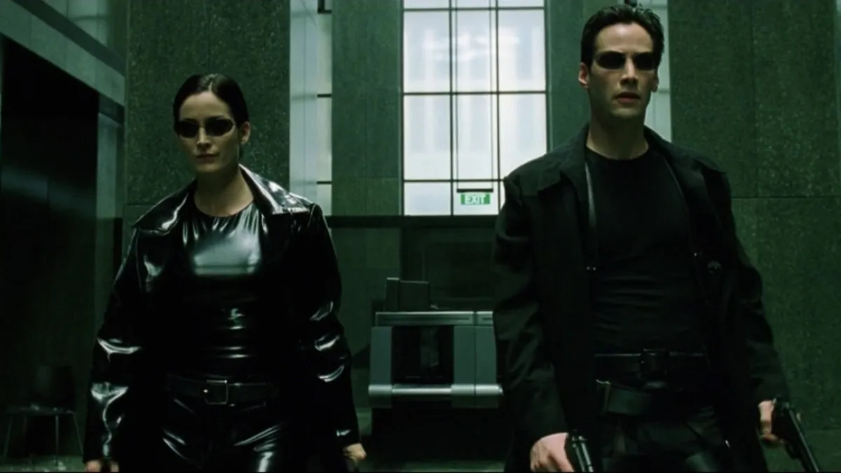 carrie-anne moss and keanu reeves as Trinity and Neo in The Matrix.