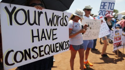 Demonstrators stand at a protest against President Trump's visit to El Paso following a mass shooting