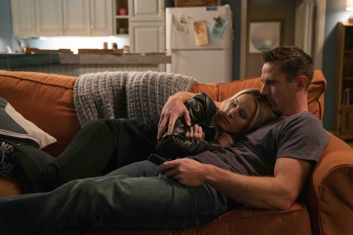 Veronica and Logan snuggle on the couch in Hulu's Veronica Mars.
