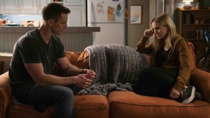 Veronica and Logan on the couch looking at each other with angst in Hulu's Veronica Mars season 4.