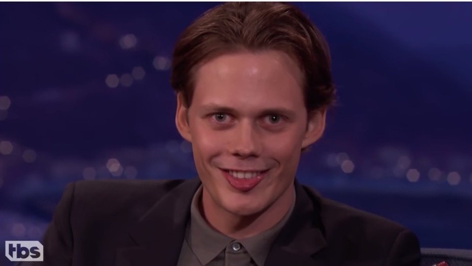 Bill Skarsgard does his Pennywise smile.