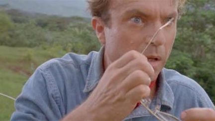 Dr. Grant removes his glasses in surprise in Jurassic Park.