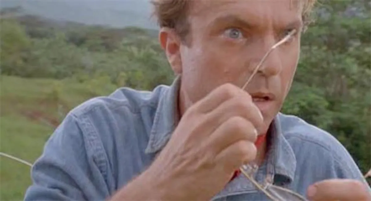 Dr. Grant removes his glasses in surprise in Jurassic Park.