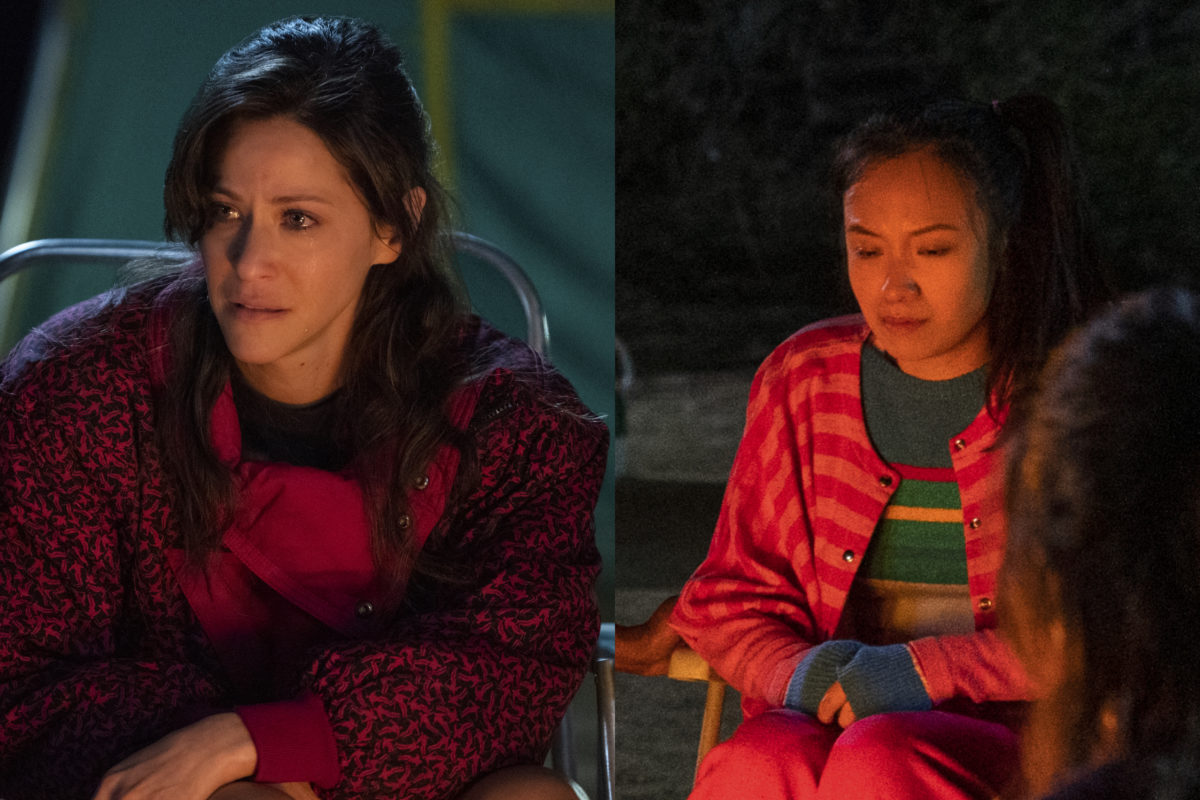 Melrose and Jenny sit around a campfire on Netflix's GLOW.