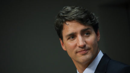 Justin Trudeau's face against a dark background.