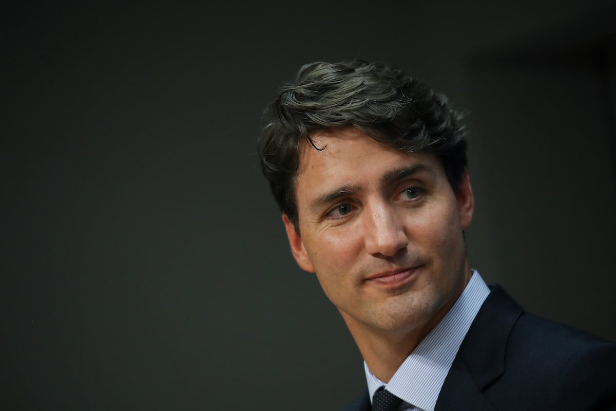 Justin Trudeau's face against a dark background.