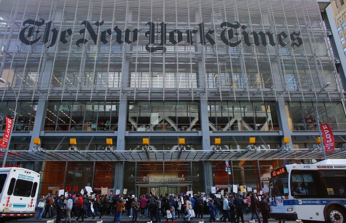People take part in a protest outside the New York Times