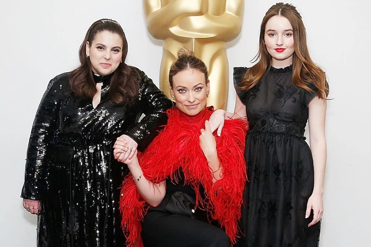 Actor Beanie Feldstein, actor, director and producer Olivia Wilde and actor Kaitlyn Dever pose in front of a life-size Oscar statue.