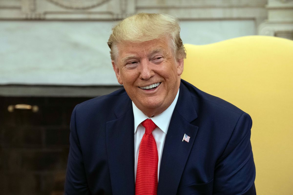 Donald Trump smirks with his orange face.